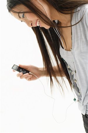 playing music on the mobile - Woman Listening to MP3 Player Stock Photo - Premium Royalty-Free, Code: 600-00864846