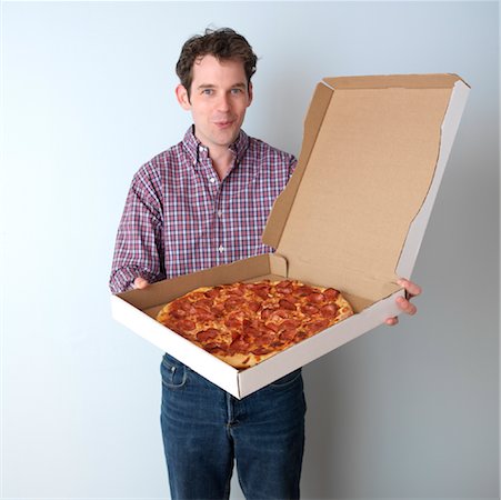 simsearch:600-02586225,k - Portrait of Man Holding Pizza Stock Photo - Premium Royalty-Free, Code: 600-00865409