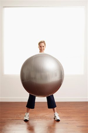Woman Holding Exercise Ball Stock Photo - Premium Royalty-Free, Code: 600-00865928