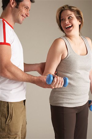 spotting at the gym - Woman With Personal Trainer Stock Photo - Premium Royalty-Free, Code: 600-00866733