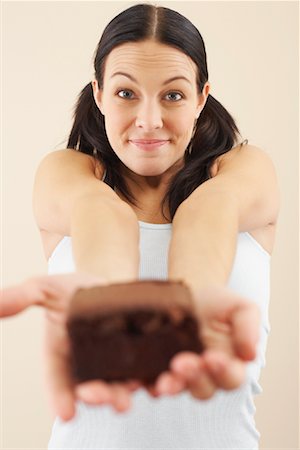 displaying chocolates - Woman Holding Brownie Stock Photo - Premium Royalty-Free, Code: 600-00866851