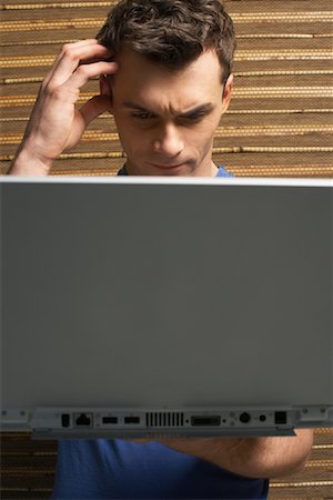 simsearch:600-01295872,k - Man Using Laptop Stock Photo - Premium Royalty-Free, Code: 600-00909505