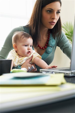 Mother Using Laptop Computer With Baby on Her Lap Stock Photo - Premium Royalty-Free, Code: 600-00909563