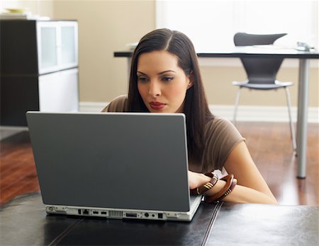 simsearch:600-00909605,k - Woman Using Laptop Computer Stock Photo - Premium Royalty-Free, Code: 600-00909602