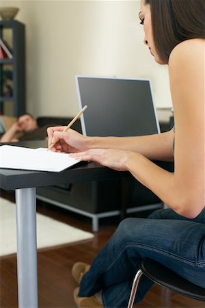 student working home office - woman Working at Computer and Man Napping on Couch Stock Photo - Premium Royalty-Free, Code: 600-00909627