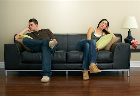 sulking arms folded - Couple Sitting on Couch Stock Photo - Premium Royalty-Free, Code: 600-00909631