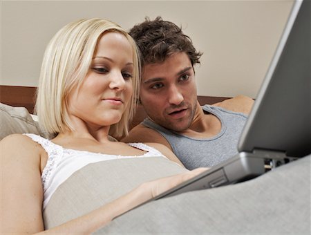 simsearch:600-00909605,k - Couple Using Laptop in Bed Stock Photo - Premium Royalty-Free, Code: 600-00917174