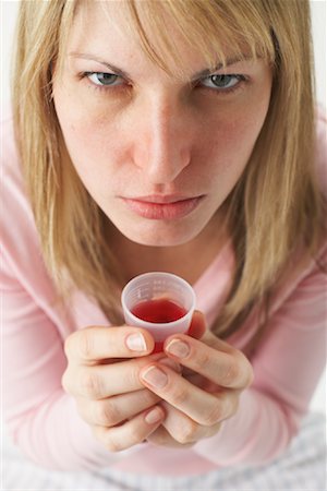 Woman Taking Cough Syrup Stock Photo - Premium Royalty-Free, Code: 600-00917296