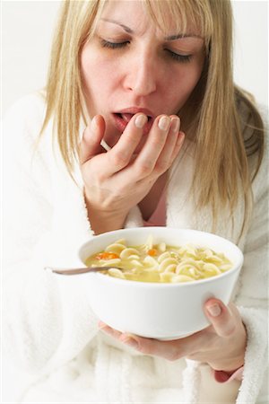female coughing - Woman Eating Chicken Noodle Soup Stock Photo - Premium Royalty-Free, Code: 600-00917305