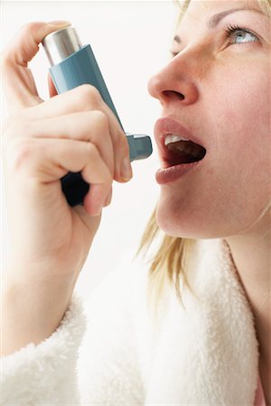Woman Using Inhaler Stock Photo - Premium Royalty-Free, Code: 600-00917307