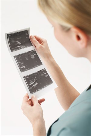 Doctor Looking at Ultrasound Stock Photo - Premium Royalty-Free, Code: 600-00917406