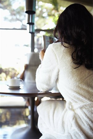 Woman Sitting At Kitchen Table Stock Photo - Premium Royalty-Free, Code: 600-00917473