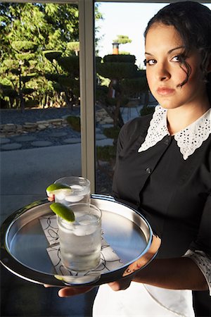 A Maid Holding Tray With Drinks Stock Photo - Premium Royalty-Free, Code: 600-00917519