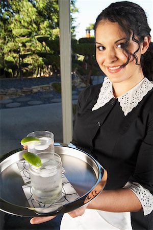 A Maid Holding Tray With Drinks Stock Photo - Premium Royalty-Free, Code: 600-00917520