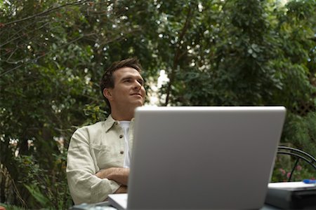 Man Sitting Outside With Laptop Computer Stock Photo - Premium Royalty-Free, Code: 600-00918549