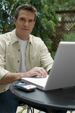 Homme assis dehors avec ordinateur portable Photographie de stock - Premium Libres de Droits, Code: 600-00918553