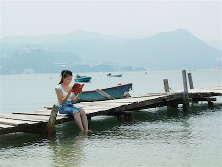 Woman Reading on Dock Stock Photo - Premium Royalty-Free, Code: 600-00910379
