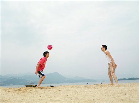 simsearch:600-01838208,k - Men Playing With Ball on Beach Stock Photo - Premium Royalty-Free, Code: 600-00910384
