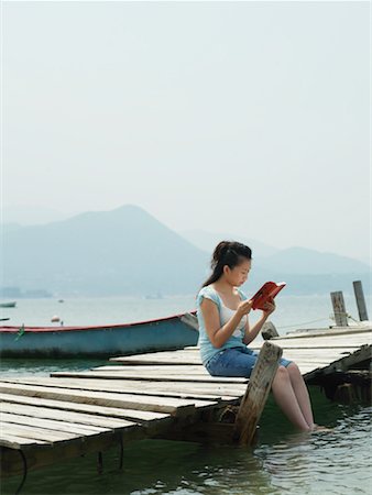 Woman Reading on Dock Stock Photo - Premium Royalty-Free, Code: 600-00910380