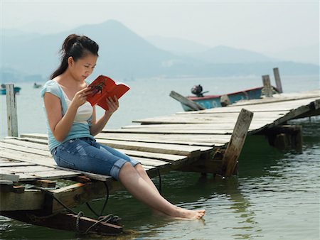 Woman Reading on Dock Stock Photo - Premium Royalty-Free, Code: 600-00910381