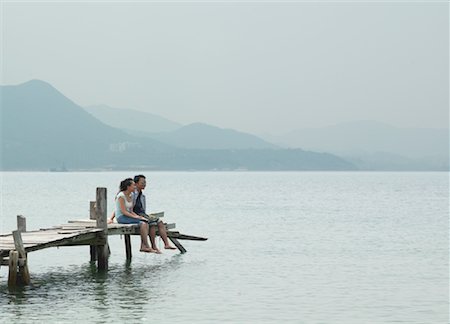 Couple Sitting on Dock Stock Photo - Premium Royalty-Free, Code: 600-00910382