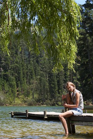 Woman Sitting on Dock Stock Photo - Premium Royalty-Free, Code: 600-00911928