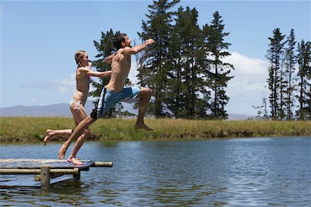 Couple Jumping into Water from Dock Stock Photo - Premium Royalty-Free, Code: 600-00911955