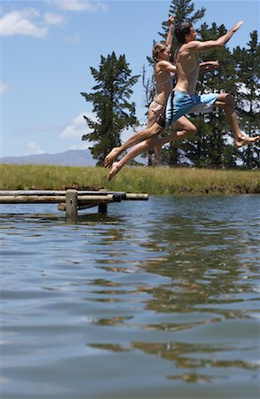 simsearch:600-01585698,k - Couple Jumping into Water from Dock Stock Photo - Premium Royalty-Free, Code: 600-00911958