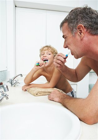 Father and Son Brushing Teeth Stock Photo - Premium Royalty-Free, Code: 600-00934219