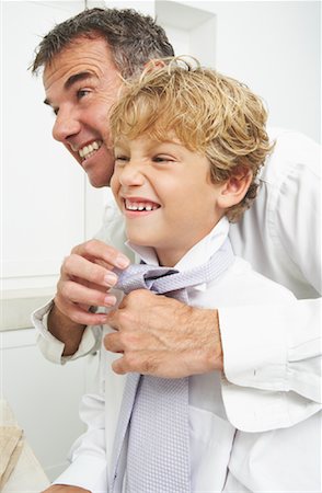 father tying sons tie - Father Helping Son Tie Necktie Stock Photo - Premium Royalty-Free, Code: 600-00934225