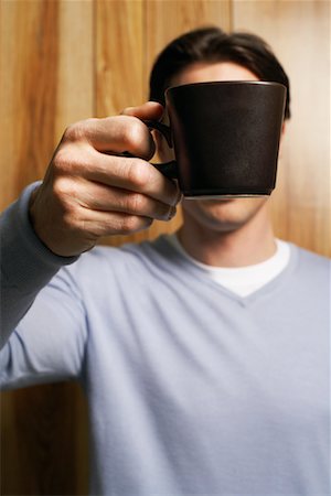simsearch:700-01124813,k - Man Holding Coffee Mug in Front of Face Stock Photo - Premium Royalty-Free, Code: 600-00934360