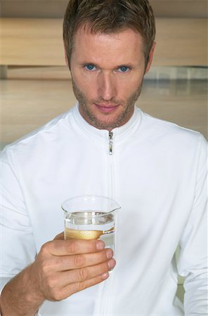 futuristic athletic wear - Portrait of Man Holding Beaker of Water Stock Photo - Premium Royalty-Free, Code: 600-00934639