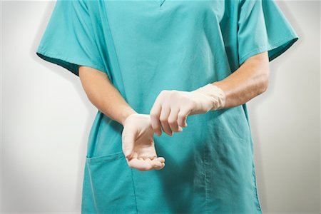 female doctor cap - Doctor Putting on Gloves Stock Photo - Premium Royalty-Free, Code: 600-00935066