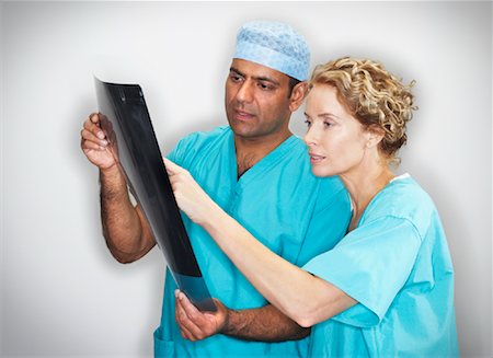 doctor looking at xray - Doctor's Examining X-Ray Stock Photo - Premium Royalty-Free, Code: 600-00935083