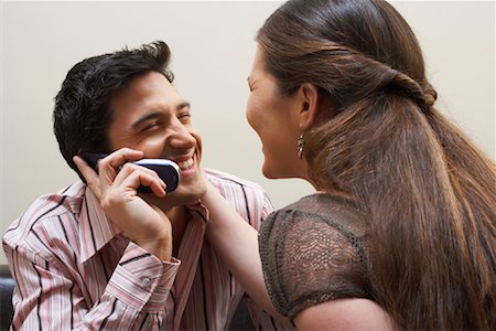 Couple Using Cellular Phone Stock Photo - Premium Royalty-Free, Code: 600-00933801