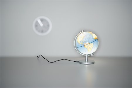 Illuminated Globe and Wall Clock Stock Photo - Premium Royalty-Free, Code: 600-00933866