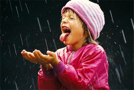 single kid playing - Girl in Rain Stock Photo - Premium Royalty-Free, Code: 600-00948341