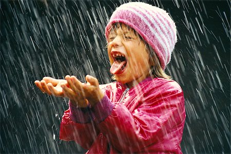 single kid playing - Girl in Rain Stock Photo - Premium Royalty-Free, Code: 600-00948342