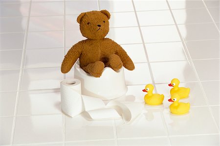 potty-training - Teddy Bear Sitting on Potty Stock Photo - Premium Royalty-Free, Code: 600-00954442