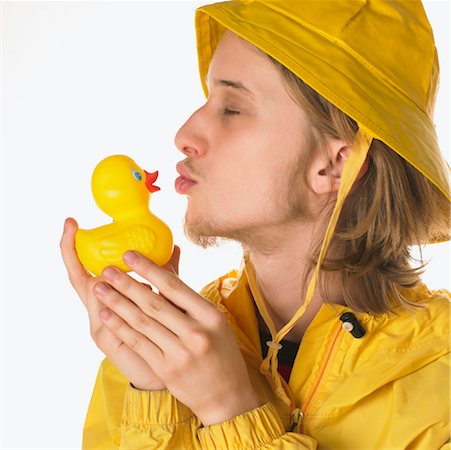 Teenager Wearing Raincoat, Kissing Rubber Duck Stock Photo - Premium Royalty-Free, Code: 600-00954487