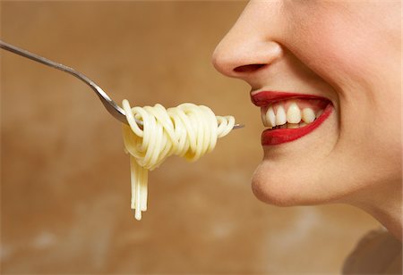 simsearch:600-00954751,k - Woman Being Fed Pasta Stock Photo - Premium Royalty-Free, Code: 600-00954745