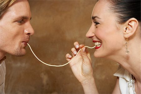 feeding - Couple Eating Pasta Stock Photo - Premium Royalty-Free, Code: 600-00954750