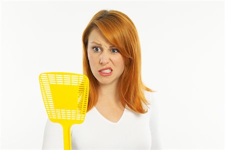 Woman Holding Fly Swatter Stock Photo - Premium Royalty-Free, Code: 600-00955307