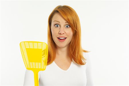 Woman Holding Fly Swatter Stock Photo - Premium Royalty-Free, Code: 600-00955308