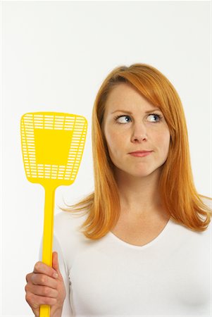 Woman Holding Fly Swatter Stock Photo - Premium Royalty-Free, Code: 600-00955309
