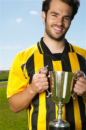 simsearch:600-01037159,k - Portrait of Soccer Player Holding Trophy Fotografie stock - Premium Royalty-Free, Codice: 600-00984031