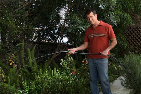 Man Watering Garden Stock Photo - Premium Royalty-Free, Code: 600-00984108