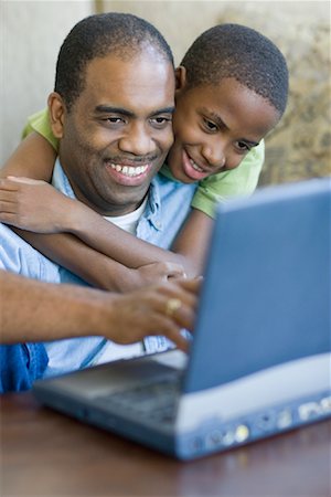 Father and Son with Laptop Computer Stock Photo - Premium Royalty-Free, Code: 600-00983414