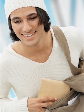 simsearch:600-02377942,k - Man Putting Envelope in Bag Stock Photo - Premium Royalty-Free, Code: 600-01014484