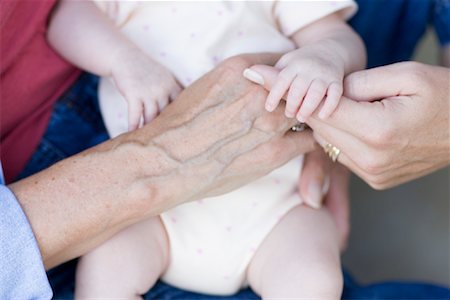 Baby in the Hands of her Mother and Grandmother Stock Photo - Premium Royalty-Free, Code: 600-01014849